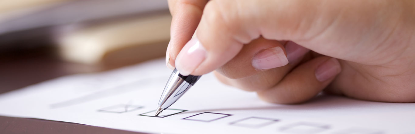 person checking boxes on paperwork