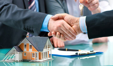 people shaking hands over paperwork